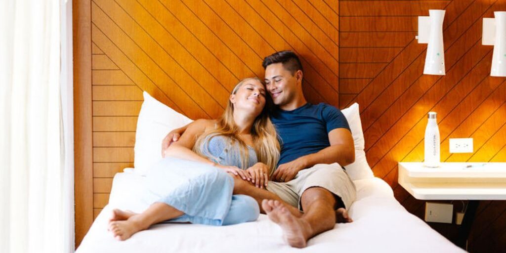 couple lounging in room on bed