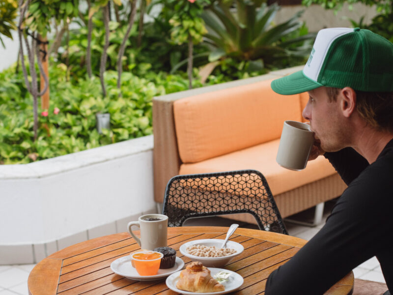 man enjoying outdoor breakfast coffee